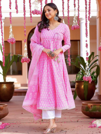 A pink anarkali floral cotton salwar suit with a dupatta is a beautiful and traditional Indian outfit. Anarkali refers to the style of the dress, which features a long, flowing silhouette with a fitted bodice and flared skirt